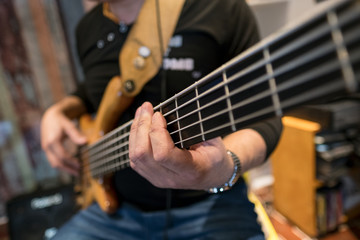 Fototapeta premium Bass Player Musician Music Instrument gear equipment string musical rock jazz blues improvisation recording hands sound electric finger art craft song rhythm 