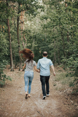 Couple spending time together. Couple is walking on the field in sunset time. Love concept