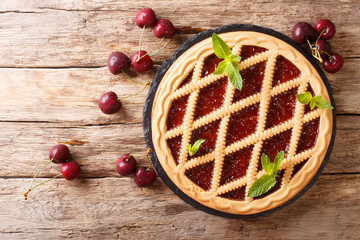 delicious open cherry pie Crostata close-up on a table. Horizontal top view