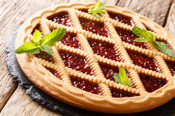 Italian cherry crostata pie decorated with mint closeup. horizontal