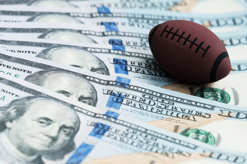Souvenir ball for playing rugby or American football on US banknotes. The concept of corruption or sports betting.