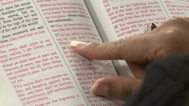 Close up shot of a young African American woman reading the Holy Bible