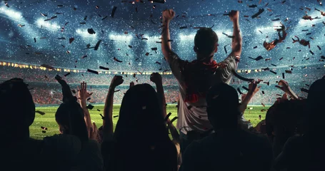 Fotobehang Fans celebrating the success of their favorite sports team on the stands of the professional stadium while it's snowing © haizon