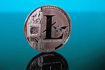 Litecoin crypto currency coin on reflective colorful background