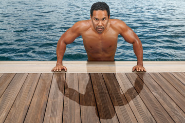 Handsome latino man gets up onto the dock.