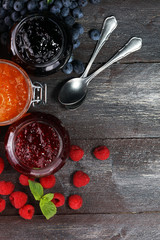 assortment of jams, seasonal berries, apricot, mint and fruits. marmalade or confiture