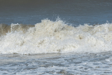 Closeup of wave crashing onto the beach.