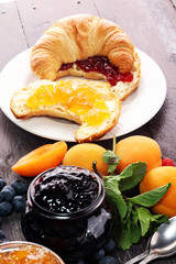 croissants with marmalade and assortment of jams, seasonal berries, apricot, mint and fruits
