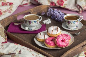 Breakfast in bed with coffee and donuts