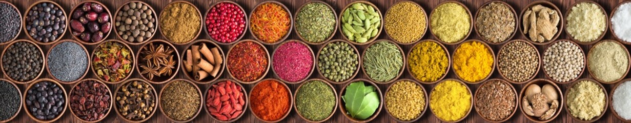 Colorful Indian spices background, top view.  large set of seasoning is lined with a rainbow