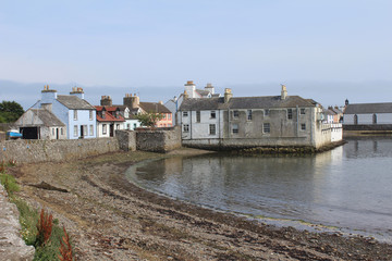Fototapeta na wymiar View of the picturesque harbour and surrounding buildings at the Isle of Whithorn in Dumfires and Galloway in Scotland. One of the most southerly ports in Scotland.