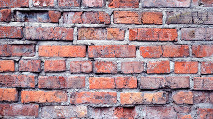 Obraz premium texture of a brick wall background in the countryside . rough blocks of stone brick masonry horizontal . architecture wallpaper.