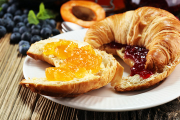 croissants with marmalade and assortment of jams, seasonal berries, apricot, mint and fruits