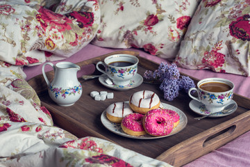 Breakfast in bed with coffee and donuts