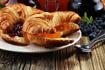 croissants with marmalade and assortment of jams, seasonal berries, apricot, mint and fruits