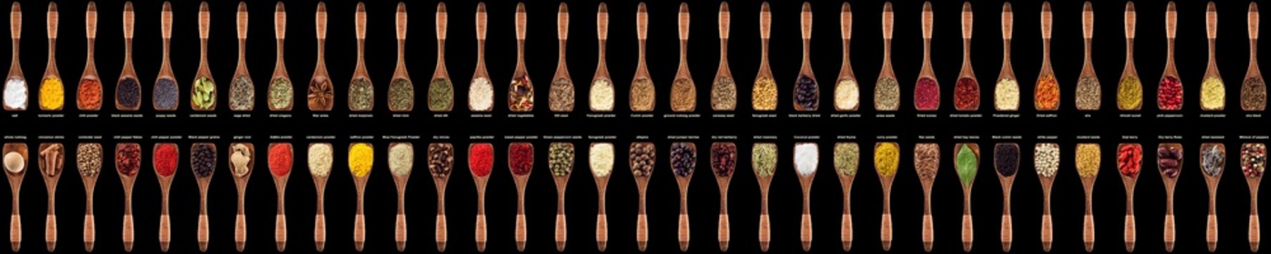 colorful spices and herbs in wooden spoons. seasoning isolated on black background. condiments for food from all over the world