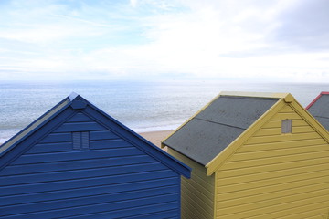colourful beach huts on mundesley beach front
