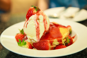 Fresh red strawberries topping vanilla ice cream on pancake seasoned with strawberry sauce. Healthy sweet dessert, Food and Beverage, Stress Therapy.