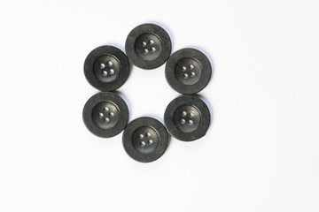 black buttons for sewing on a white background