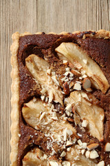 Tart with pear and almond filling and decoration. Top view, close-up.

