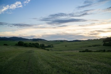 Fototapeta premium Sunrise and sunset over the hills and town. Slovakia