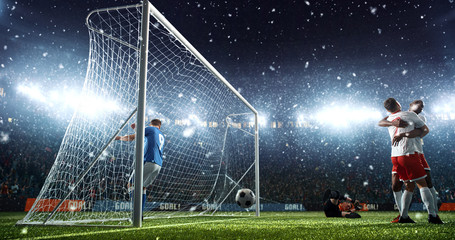 Intense soccer moment in front of the goal on the professional soccer stadium.