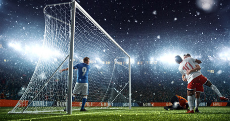 Intense soccer moment in front of the goal on the professional soccer stadium.