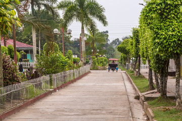 A MotoKar driving on a paved road in Amazon village of Indiana, Peru