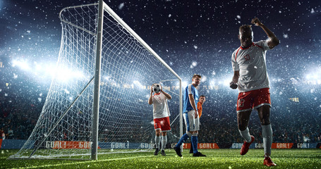 Intense soccer moment in front of the goal on the professional soccer stadium.