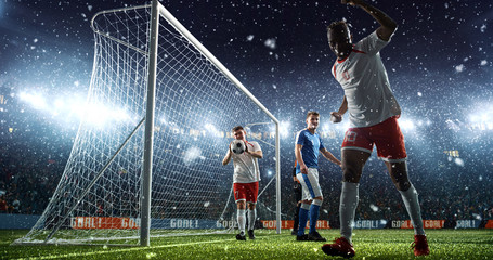 Intense soccer moment in front of the goal on the professional soccer stadium.
