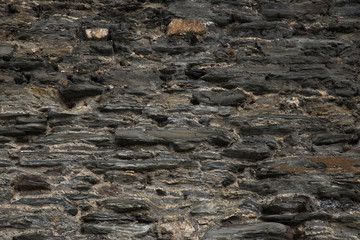 Decor texture with the structure of grew-brown stone wall  