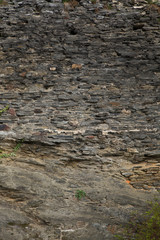 Decor texture with the structure of grew-brown stone wall  