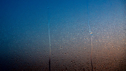 Raindrops on the window with abstract lights
