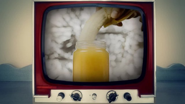 A retro vintage TV showing plunging a peeled banana in a jar of yellow honey (metaphor for sexual intercourse, use it when you must visually show but you can't put the real thing).
