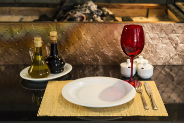 plate,glass,fork,knife and service napkins on the black background for restaurant and cafe concept.