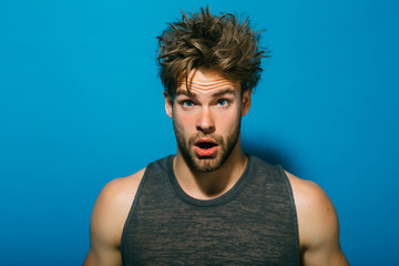 Morning concept. Bachelor with unshaven face and messy hair in morning. Surprised guy awaken in...