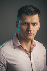 Fototapeta premium Man with serious young face. Macho wear fashionable shirt. Handsome guy with stylish hair. Youth fashion and style concept