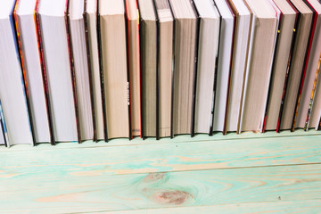 Pile of various books on wooden background