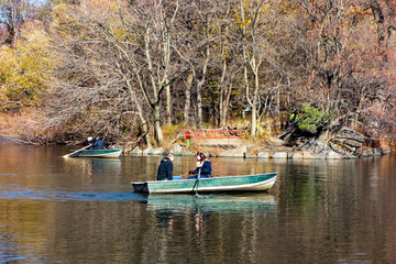 Fototapeta na wymiar Boating in Central Park during the fall autumn season. Rented Boats on Lake (south of the Great Lawn). New York. NY, USA,