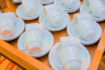  cups with saucer on wooden table