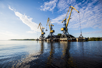 A view of the port cranes against blue sky. Riga, Latvia
