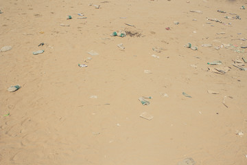 earth pollution result of human activity concept of many garbage objects on dirty sand background texture with empty space for copy or text