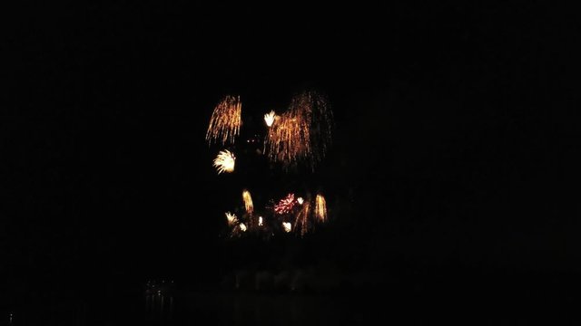 Aerial footage of fireworks over water. Rhine, Hesse, Germany.