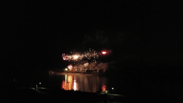 Aerial footage of fireworks over water. Rhine, Hesse, Germany.