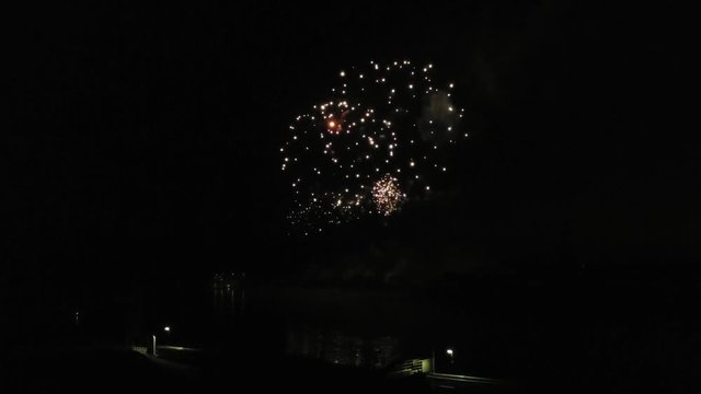 Aerial footage of fireworks over water. Rhine, Hesse, Germany.