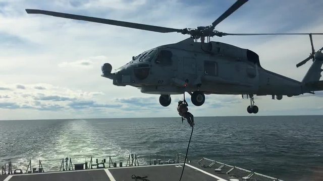 Special forces fast rope training from helicopter at sea