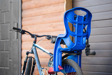 Bike with children carrying  seat attached. Cycle with kids transportation equipment stand near...
