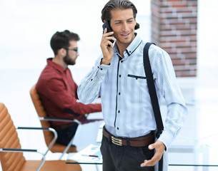 man talking on smartphone in office