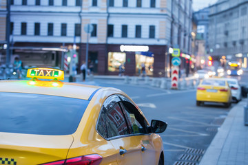 yellow taxi in the evening on the city