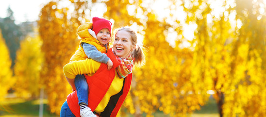 happy family  mother   and baby son on   autumn walk